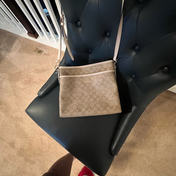 Coach Handbags - The Coach Crossbody bag in Light Khaki exudes a delightful, gently worn charm.